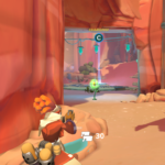 Character charging an ability behind a rock in a vibrant desert landscape.