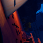 A colorful, abstract landscape from the video game Road 96, featuring warm lighting and scattered geometric shapes.