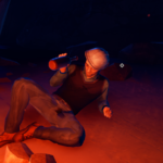 A character lies on the ground near a campfire, holding a bottle and smiling in a dark, rocky environment.