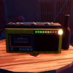 A colorful retro radio on a wooden table next to a bottle.