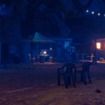 A dimly lit campsite with rustic structures, chairs, and string lights, set in a rocky environment.