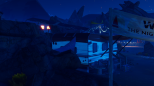 A nighttime scene from a video game, featuring a blue-toned landscape with a trailer and a flag.