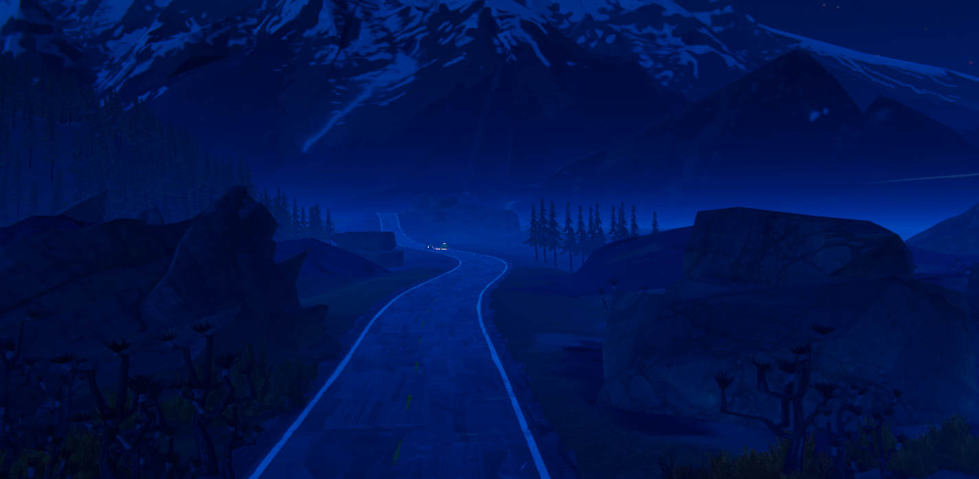 A winding road through a dark mountain landscape, illuminated by a distant light.