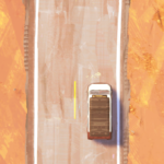 A top-down view of a white truck driving on a winding road through a desert landscape.