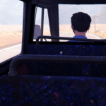A view from inside a bus, showing the back of a character's head as they look out at a desert landscape.
