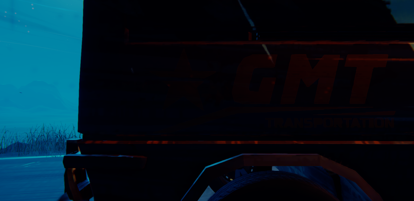 Close-up of a truck with the logo "GMT Transportation" in a dark, blue-lit environment.