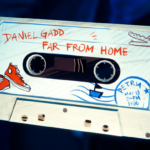 Cassette tape labeled "Daniel Gadd - Far From Home" with illustrations of sneakers and a boat.