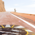 A winding road along a rocky cliff in a desert landscape.