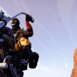 A masked character holds a weapon while riding a motorcycle in a desert landscape.