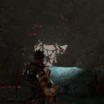 A character stands before a dark, rocky opening with organic, tendril-like structures visible.