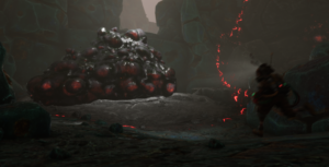 A character approaches a large, globby mass with red orbs surrounded by rocky terrain and glowing elements.