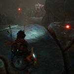 Character standing on a rocky surface, observing glowing red dots in a dark, cavernous environment.
